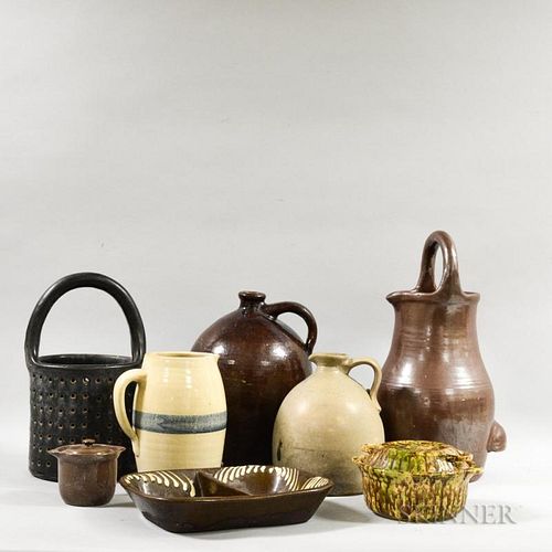 Eight Pieces of Stoneware Pottery, including a tortoiseshell-glazed covered dish, a slip-glazed redware dish, a pierced handl