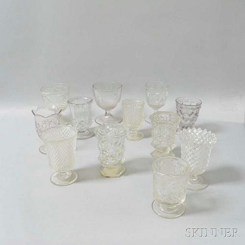 Twelve Colorless Pressed Glass Goblets and Spooners, 19th century, ht. to 5 3/4 in.