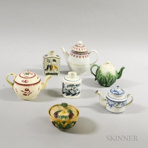 Seven English Creamware and Pearlware Items, including a cauliflower teapot and two blue and white tea caddies, (imperfection