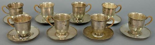Set of eight sterling silver demitasse cups and saucers, hand hammered with reed wrapped handles. 22.4 t oz.