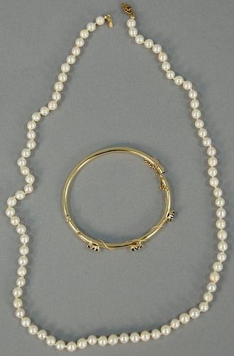 Two piece lot to include 14K gold bangle bracelet set with blue sapphires and simple pearl necklace with 14K clasp.