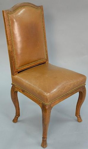 French provincial style side chair covered in leather set on hoof feet, late 18th century.