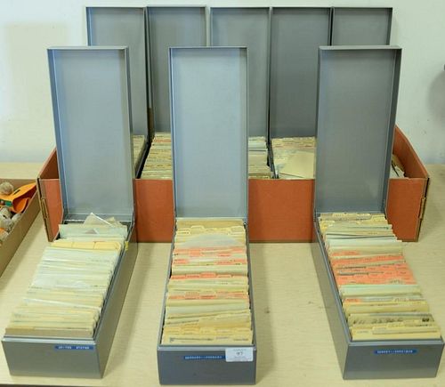 Eight metal lift top boxes of sorted stamps from many different countries.