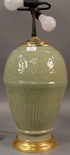 Large celadon glazed porcelain vase with incised scrolling leaf and vine decoration made into a table lamp, top cut down.  va