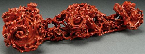 A CHINESE CARVED WOOD AND RED LACQUERED RUYI