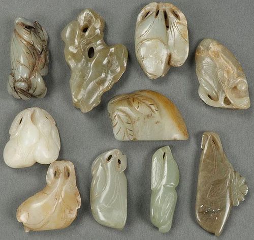 A GROUP OF TEN CHINESE CARVED JADE PENDANTS