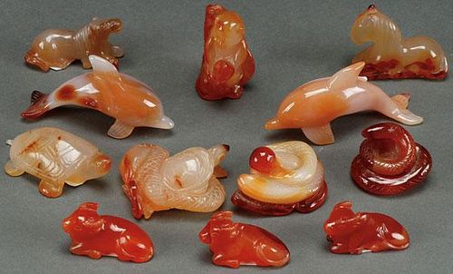 A GROUP OF 12 CHINESE CARVED CARNELIAN AGATE