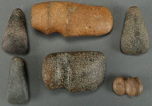 A GROUP OF SIX POLISHED STONE AX HEADS AND CELTS