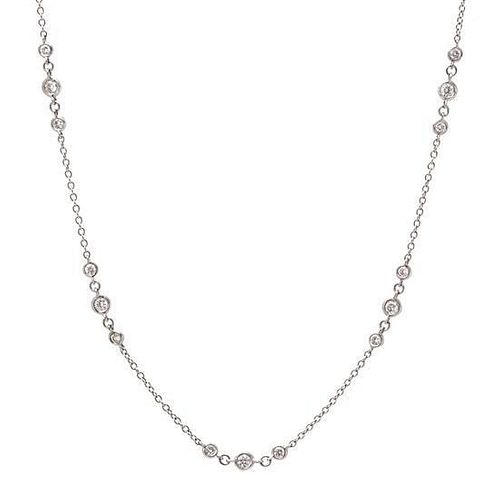An 18 Karat White Gold and Diamond Station Necklace, 3.50 dwts.