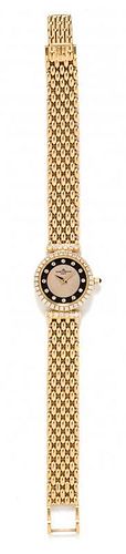 * An 18 Karat Yellow Gold and Diamond Wristwatch, Baume & Mercier, 23.90 dwts.