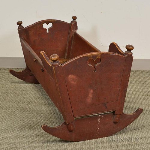 Early Red-painted Pine Cradle, Pennsylvania, 18th/19th century, with cutout heart handhold, ht. 21, wd. 41, dp. 25 1/2 in.