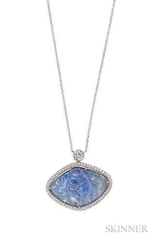 Platinum, Carved Sapphire, and Diamond Pendant, the carved tablet with floral and foliate motifs, weighing 33.24 cts., in a p