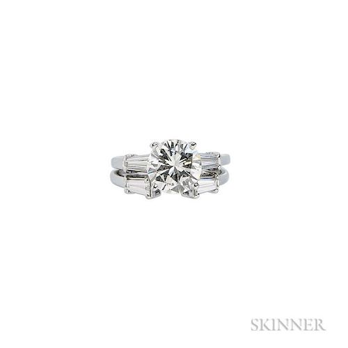 Platinum and Diamond Solitaire, prong-set with a round brilliant-cut diamond weighing 2.40 cts., flanked by tapered baguettes