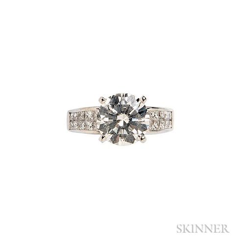 Platinum and Diamond Ring, centering a prong-set round brilliant-cut diamond weighing 3.00 cts., flanked by fancy-cut diamond