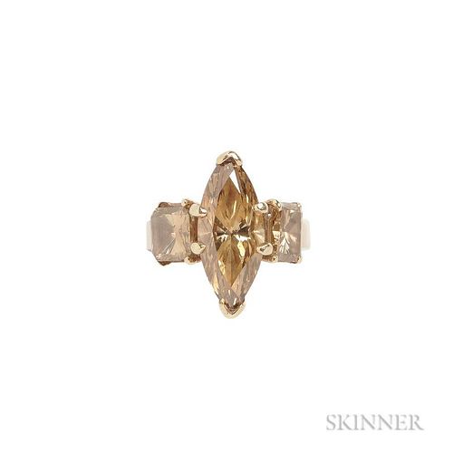 Colored Diamond Ring, centering a brown colored marquise-cut diamond measuring approx. 17.30 x 7.69 mm, flanked by two brown 