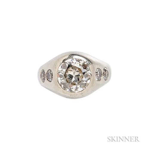 Diamond Ring, centering a flush-set old European-cut diamond weighing approx. 3.15 cts., flanked by flush-set old European-cu