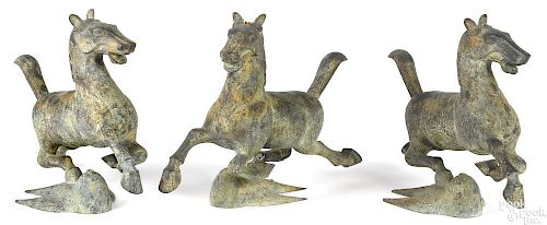Three patinated bronze leaping horses
