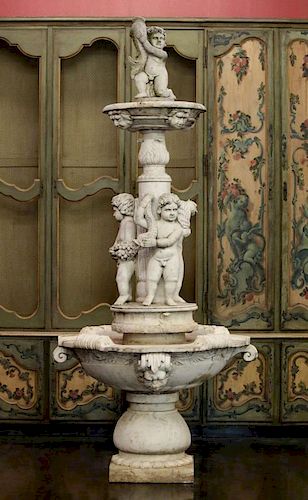 A NEOCLASSICAL MARBLE FOUNTAIN WITH PUTTO, 9 FEET