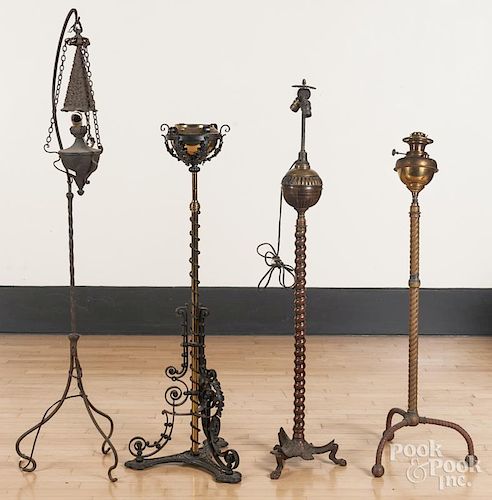 Four aesthetic movement brass and iron floor lamps