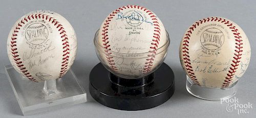 Three signed team baseballs