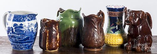Six assorted pottery and porcelain pitchers