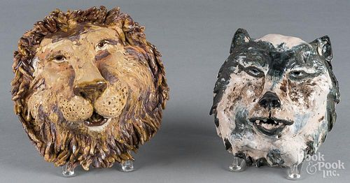 Two pottery masks of a lion and wolf
