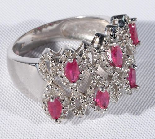 14 karat white gold cocktail ring set with six marquis cut red stones, all surrounded by diamonds. size 8