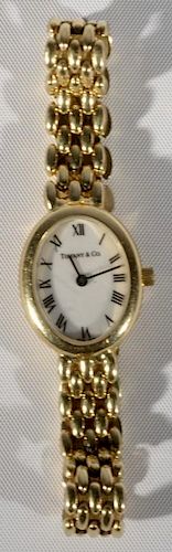 14 karat gold Tiffany & Co. ladies oval wrist watch with 14 karat gold band, band, face, and back all marked Tiffany & Co. to