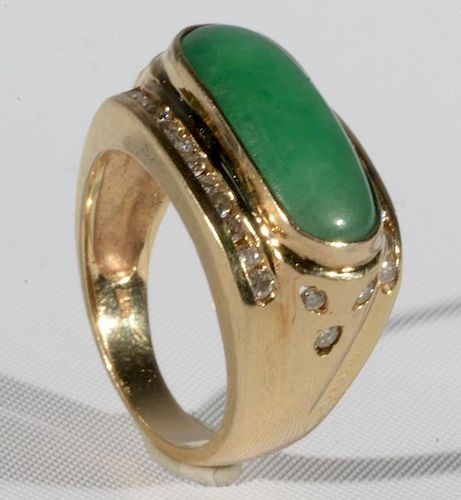 14 karat gold ring set with long oval green jade surrounded by diamonds. size 8