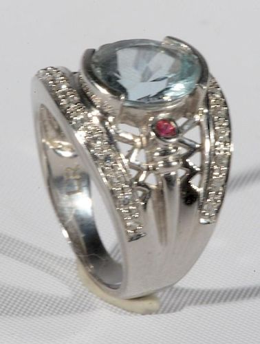 Ladies 14 karat white gold 12x9mm aquamarine ring, two 2mm round rubies and twenty-six melee diamonds, set thirteen north/sou
