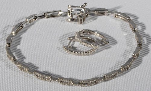 14 karat gold bracelet and earrings set with small diamonds
