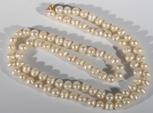 String of cultured pearls with 14 karat clasp. 9.3mm, lg. 36in.