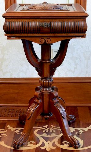 Mahogany stand having carved lift top on pedestal base set on claw feet having felt lined interior. ht. 30in., top: 16 1/2" x
