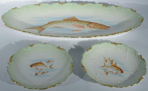 Thirteen piece Limoges fish set with ten plates, platter, sauce boat, and underplate. platter: lg. 24in., plates: dia. 9 1/2i