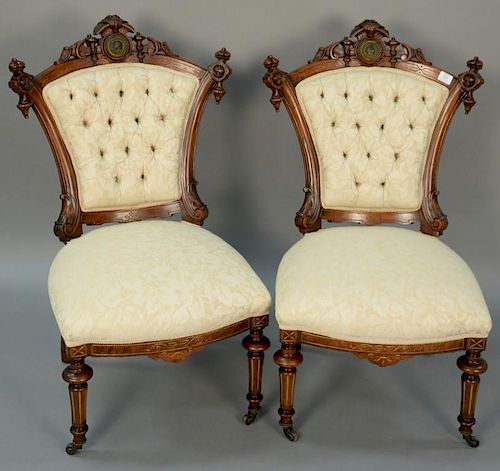 Pair of Renaissance Revival walnut side chairs, each mounted with embossed bronze plaque