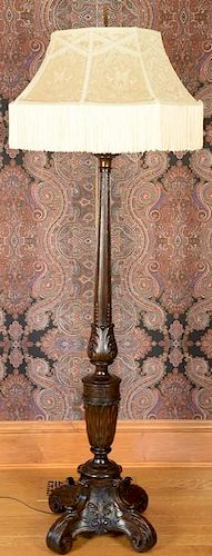 Carved oak floor lamp with custom silk shade. ht. 72in., dia. 25 1/2in. Provenance: Property from the Estate of Frank Perrott