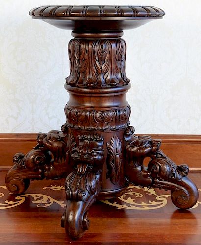 Mahogany pedestal having round top with carved edge on large acanthus carved central pedestal set on four legs with carved fa