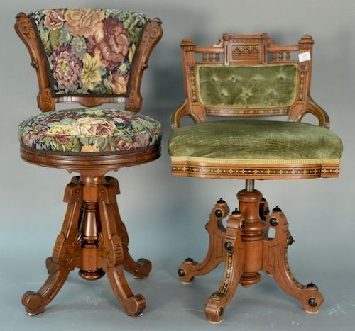 Two victorian walnut piano stools with upholstered seat and back and floral inlaid adjustable height frame and legs, along wi