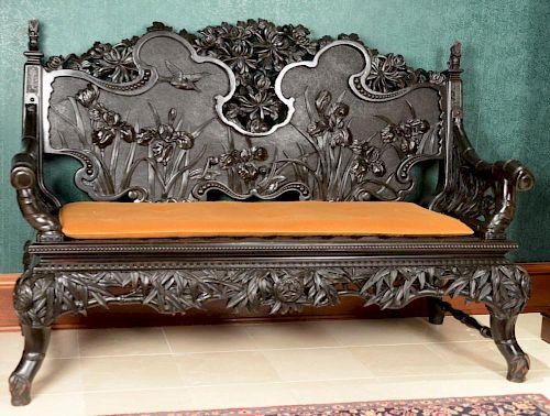 Chinese hardwood settee with pierce carved back and bamboo arms over pierce carved panels set on bamboo style legs. ht. 45in.