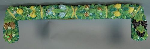 Majolica valance tiles with fruit, leaves, and pine cones in six parts mounted on painted wood backing, late 19th - early 20t