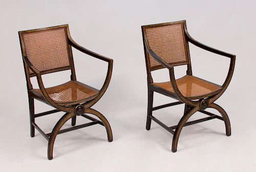PAIR OF REGENCY STYLE CANED, EBONIZED AND PARCEL-GILT ARMCHAIRS