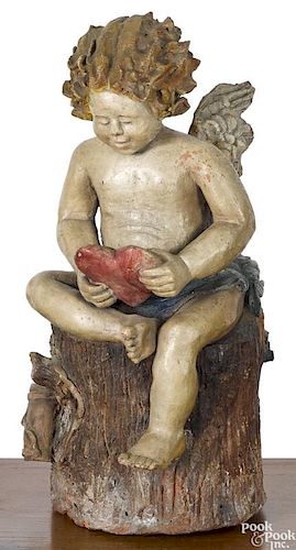 Painted redware figure of cupid atop a stump