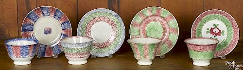 Four rainbow spatter cups and saucers