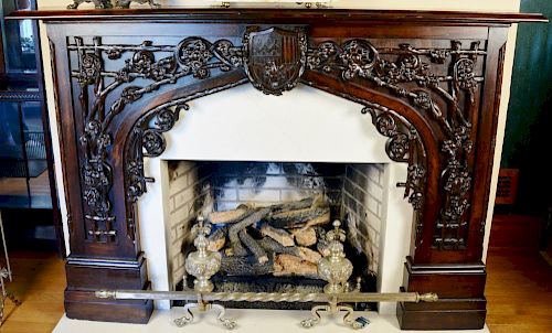 Walnut carved mantle with twig and floral three dimensional carving with center shield. ht. 51in., wd. 72in., opening: ht. 41