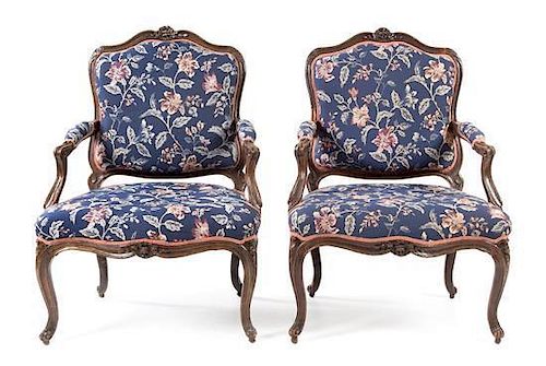A Pair of Louis XV Walnut Fauteuils Height 37 1/2 inches.