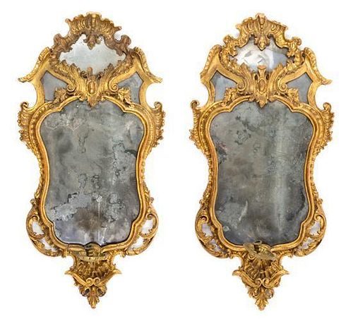 A Pair of Italian Rococo Giltwood Girandole Mirrors Height 33 x width 16 1/4 inches.