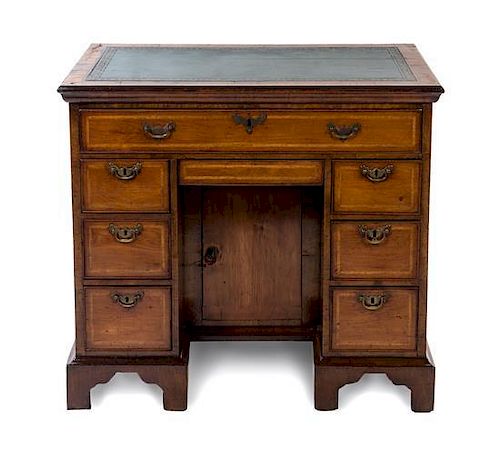 A George II Walnut Kneehole Desk Height 31 x width 34 1/8 x depth 20 3/8 inches.