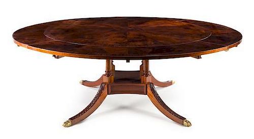 A Regency Style Mahogany Dining Table Height 29 x width 62 inches (closed).