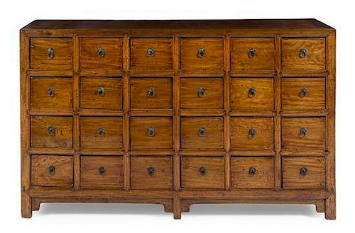 A Chinese Elmwood Apothecary Chest Height 38 x width 63 x depth 17 1/2 inches.