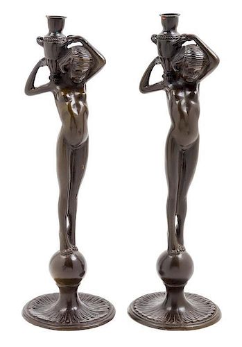 * A Pair of Patinated Metal Figural Candlesticks Height 15 5/8 inches.